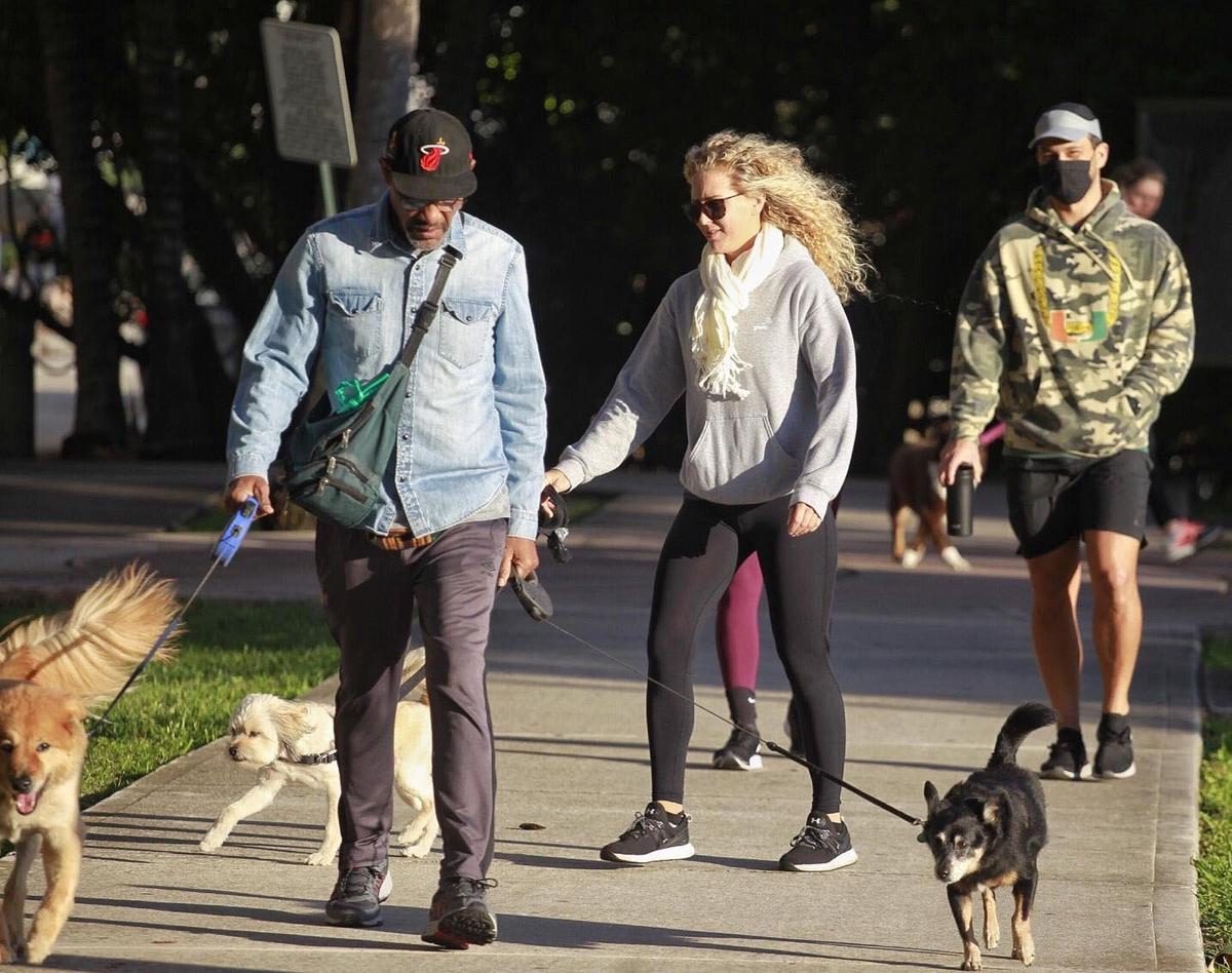 Residents of Miami’s Edgewater neighborhood stroll with friends, pets, and children at Margaret Pace Park wearing hoodies, sweaters, and cool weather attire as seasonal cool air arrived in South Florida on Tuesday, Dec. 1, 2020.