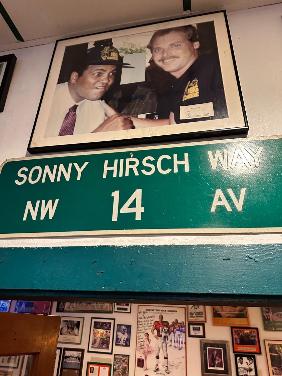 The Champ Muhammad Ali on The Big Cheese wall of fame above a street signed named after the Miami Orioles/Miami Marlins general manager Sonny Hirsch, a sports announcer voice of Miami Hurricanes football for 28 seasons. Hirsch died in 1999.
