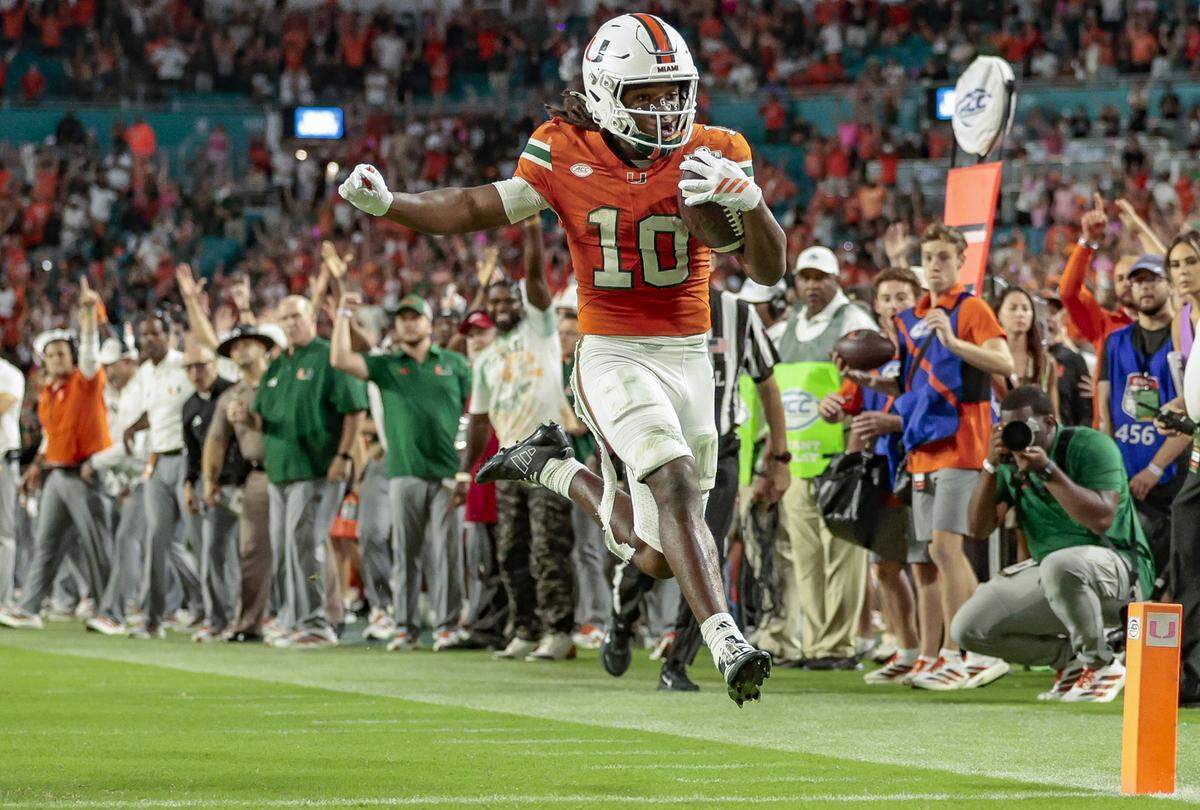 Miami Hurricanes wide receiver Malachi Toney (10) runs in to score against the Louisville Cardinals in the second half of their NCAA football game at Hard Rock Stadium in Miami Gardens, Florida, on Friday, October 17, 2025.