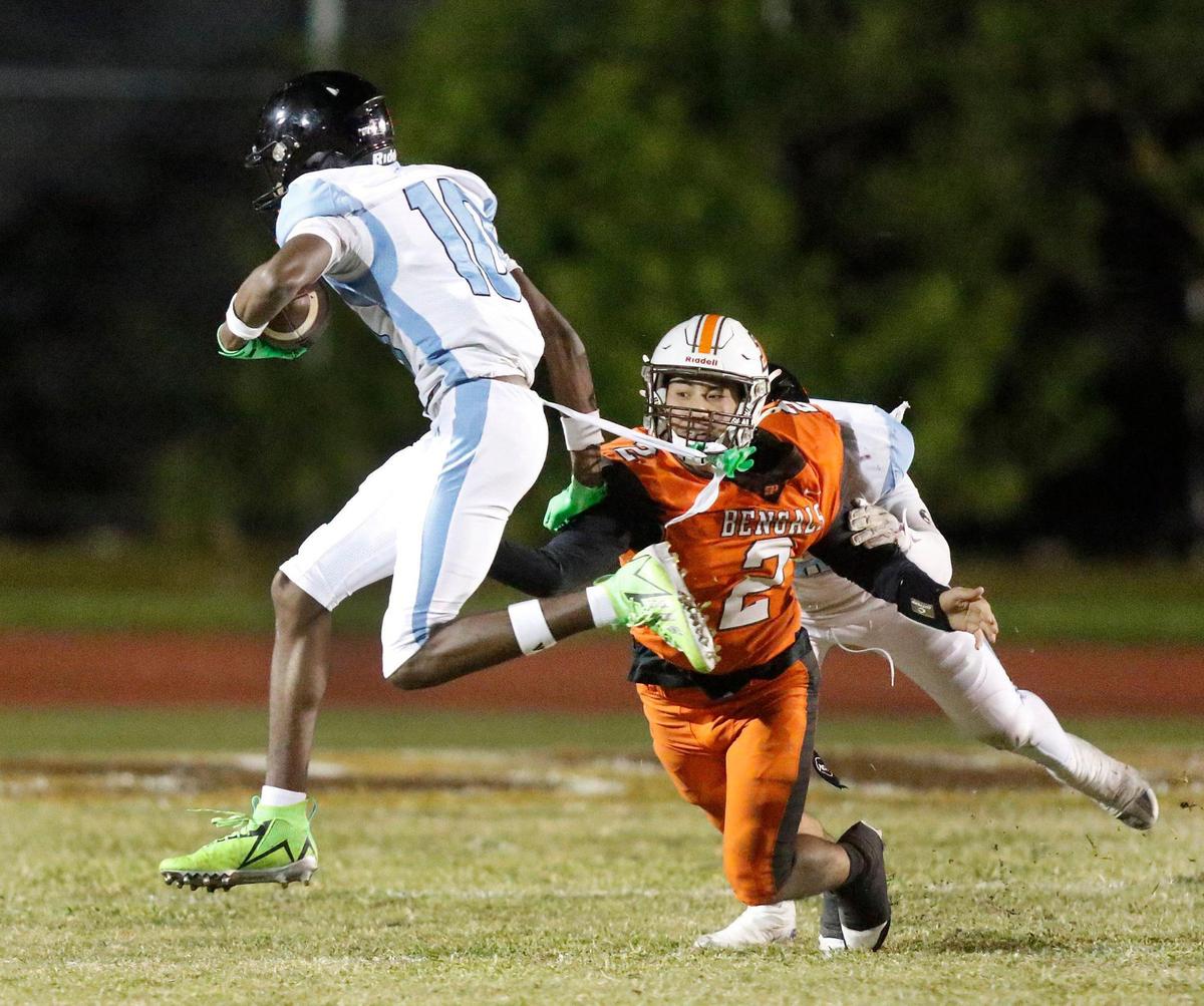 West Broward Bobcats wide receiver Amir Sear (10) tries to break free from Piper Bengals defender during Region 4-6A semifinal football game on Friday, November 22, 2024 at Piper HS in Sunrise. Andrew Uloza / for Miami Herald