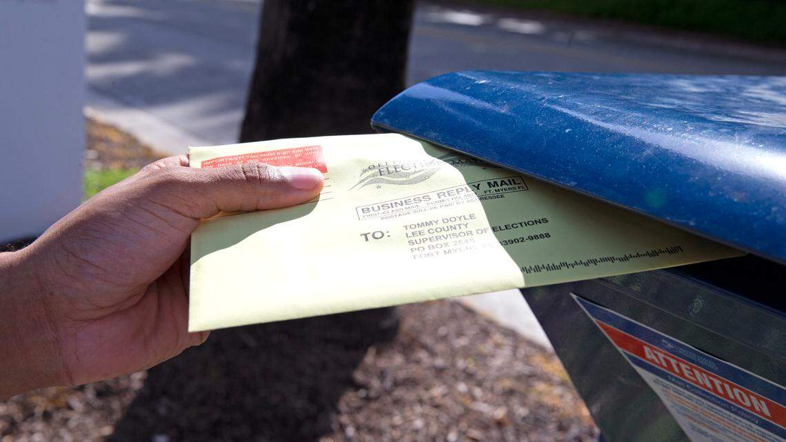 File photo of Miami-Dade resident James Curity depositing a ballot in a USPS mail collection box outside the Miami Beach City Hall during early voting for the general election on Wednesday, Oct. 28, 2020, in Miami Beach.