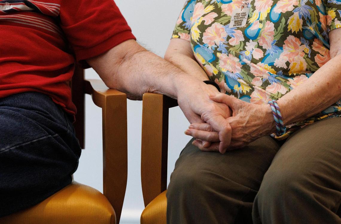 David Marans, left, holds his wife Sandy’s hand during an Interfaith Conversation Series called “A Reverend and a Rabbi” at Vi at Aventura retirement community.