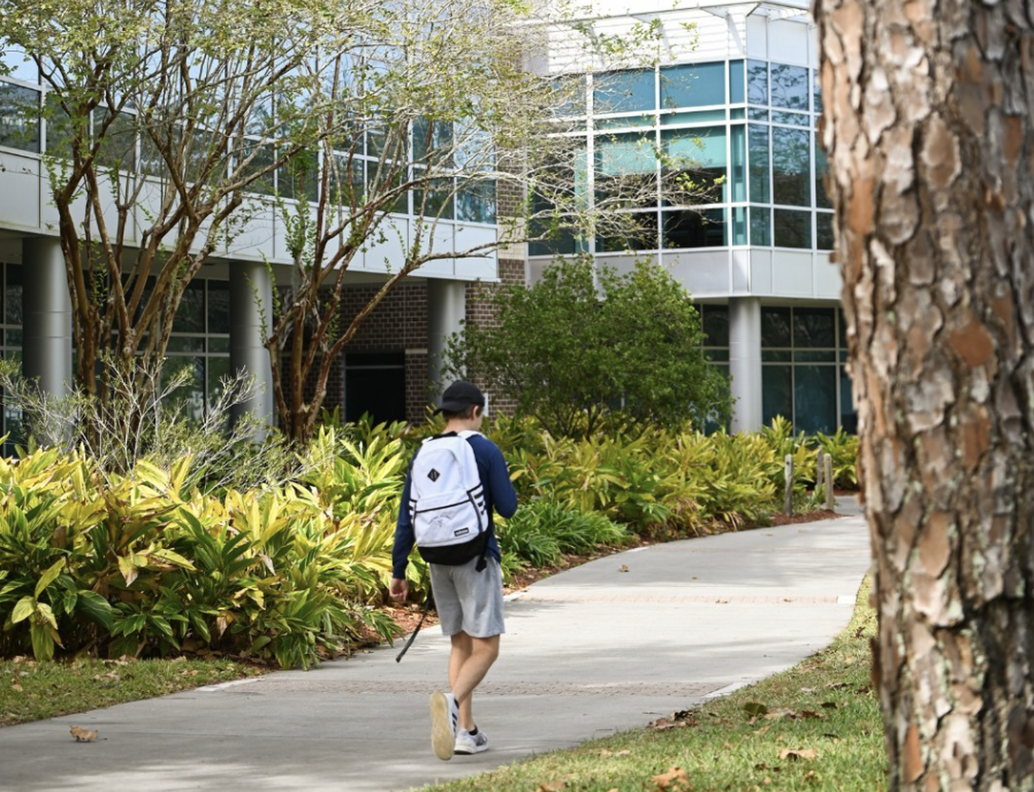 A student walks on the campus of the University of North Florida.