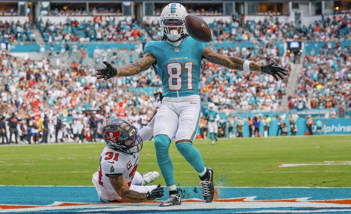 Miami Dolphins wide receiver Theo Wease Jr. (81) scores as Tampa Bay Buccaneers safety Antoine Winfield Jr. (31) defends during the first half of the NFL football game at Hard Rock Stadium in Miami Gardens, Florida, on Sunday, December 28, 2025.