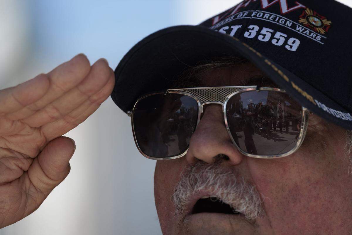 Joe Pigg, veteran and member of Veterans of Foreign Wars 3559, salutes during the National Anthem at Memorial Day Commemoration on Monday, May 25, 2026, at Miami Beach Police Headquarters in Miami Beach, Fla. 