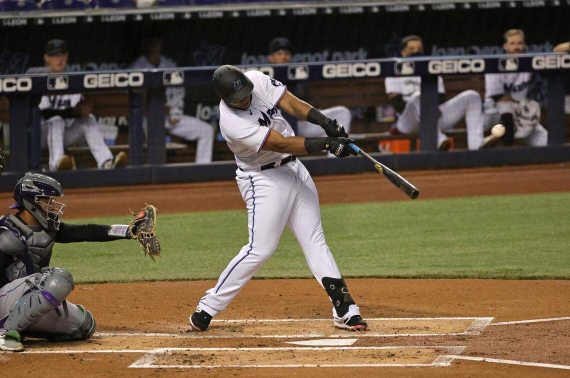 Miami Marlins first baseman Jesus Aguilar (24) hits a single during the first inning of their baseball game against the Colorado Rockies at loanDepot park on Wednesday, June 9, 2021 in Miami, Florida.