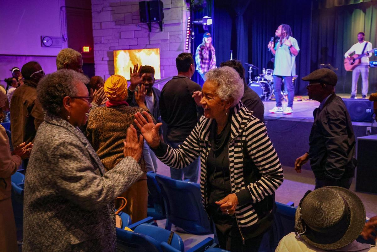 Members of Collab.Church greet one another during Sunday service on January 21, 2024, inside the auditorium of the North Dade Middle School in Miami Gardens, Florida