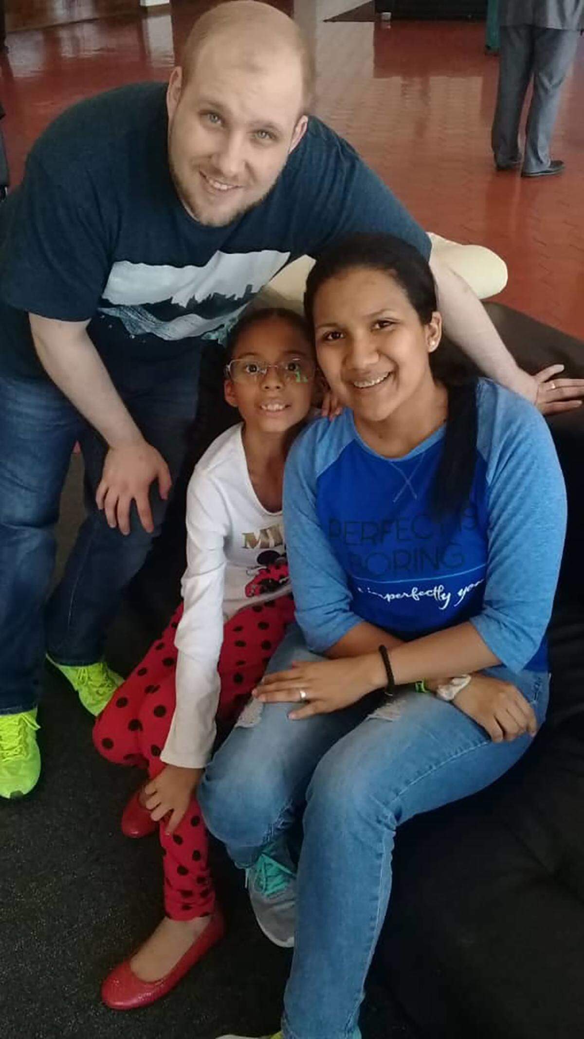 In this image provided by the Holt family, Joshua Holt poses for a photo with his wife Thamara and her daughter, at the airport in Caracas, Venezuela, Saturday, May 26, 2018.  Jailed in Venezuela on weapons charges nearly two years ago, Holt was released Saturday after a U.S. senator pressed for his freedom in a surprise meeting with President Nicolas Maduro. Holt and his wife, who also jailed, were reunited with her daughter from a previous relationship at Caracas’ airport where the three boarded a chartered flight to Washington. (Holt family photo via AP)