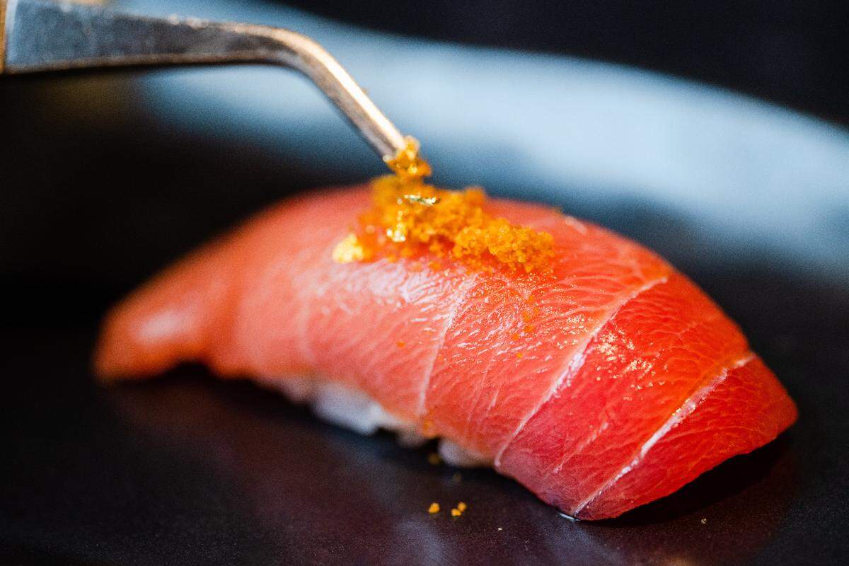 Medium-fatty toro with roe on top from Blind Tiger. After adding the roe, the chef adds gold flakes.