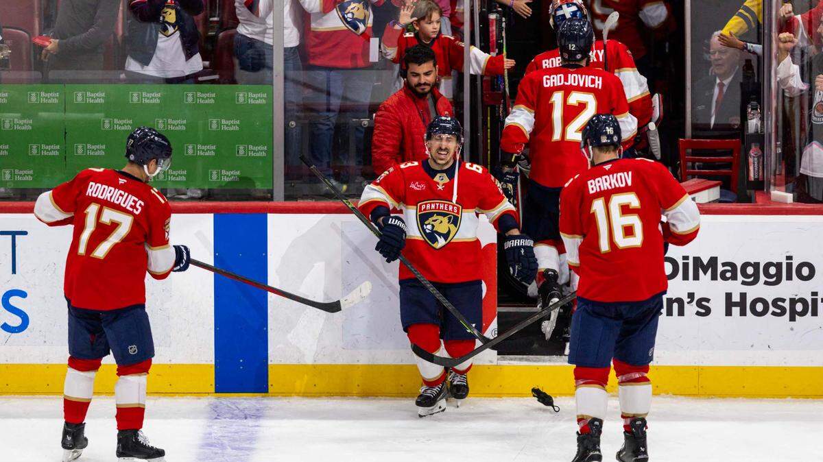 Florida Panthers center Brad Marchand (63) reacts to being hit with rats by teammates Aleksander Barkov (16) and Evan Rodrigues (17) after defeating the Detroit Red Wings 4-1 during the third period of an NHL game at Amerant Bank Arena on Thursday, April 10, 2025, in Sunrise, Fla.