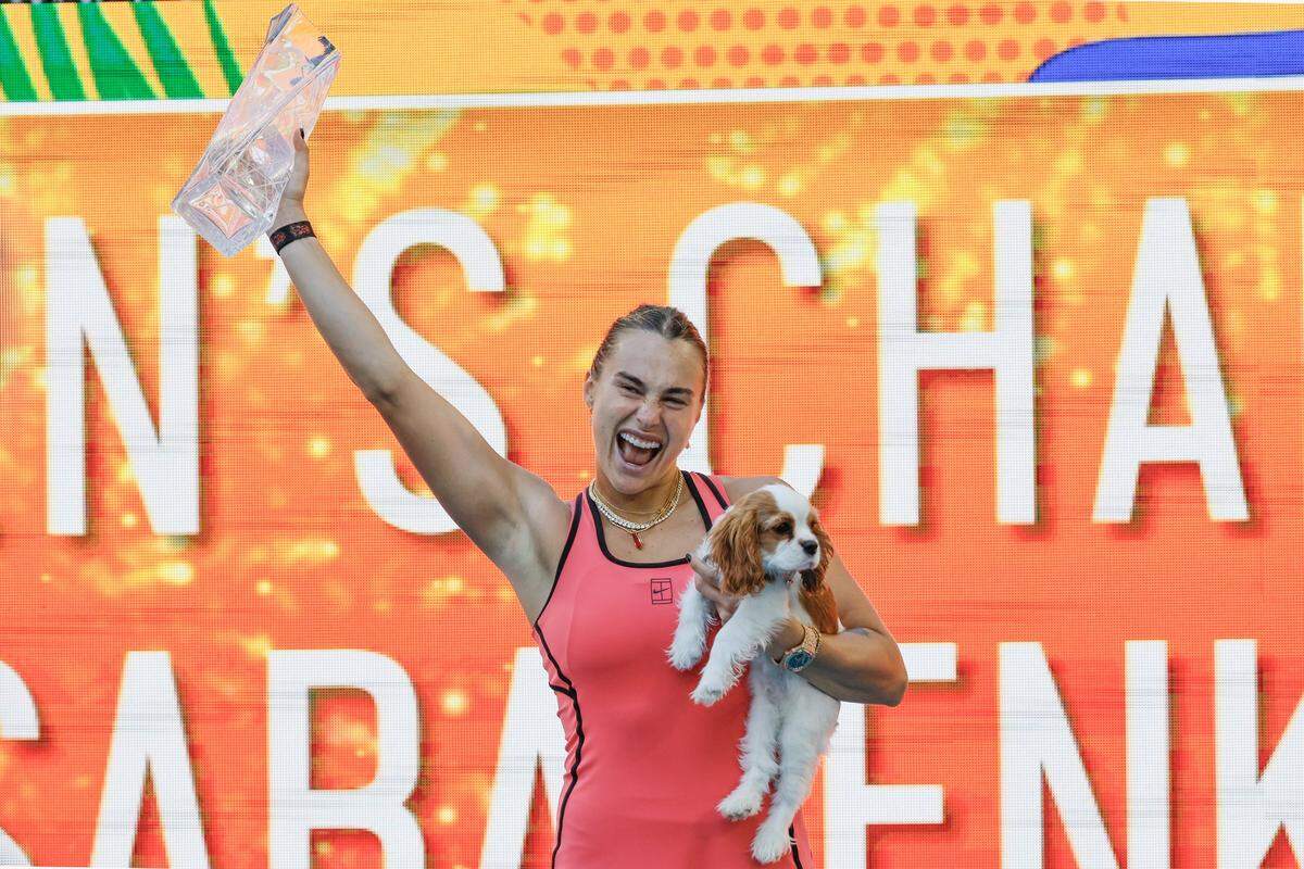 Aryna Sabalenka holds her dog Ash as she lifts the Butch Buchholz trophy after defeating Coco Gauff during the women's singles title during the Miami Open at Hard Rock Stadium in Miami Gardens, Florida, on Saturday, March 28, 2026.