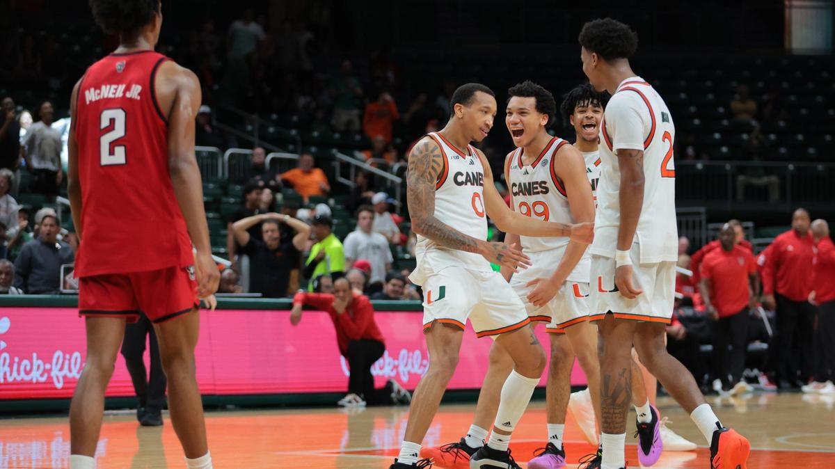 Miami Hurricanes forward Brandon Johnson (2) celebrates with guard Matthew Cleveland (0) and guard Divine Ugochukwu (99), after scoring the game-winning basket against the North Carolina State Wolfpack during the second half of their ACC basketball game at the Watsco Center in Coral Gables, Florida on Saturday, March 8, 2025.