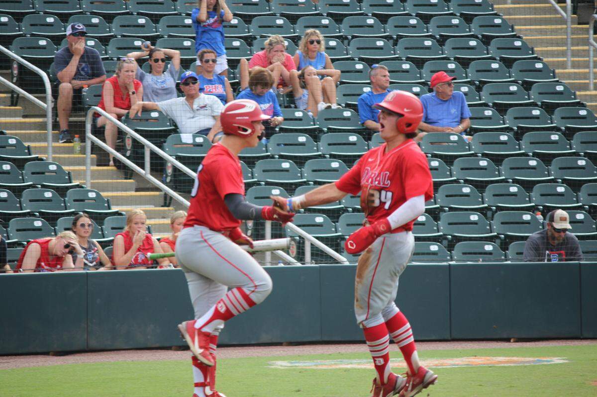 Doral’s Michael Torres is congraulated at the plate after scoring a Firebirds run in the fifth inning of Saturday’s Class 6A state championship game at Hammond Stadium in Fort Myers.
