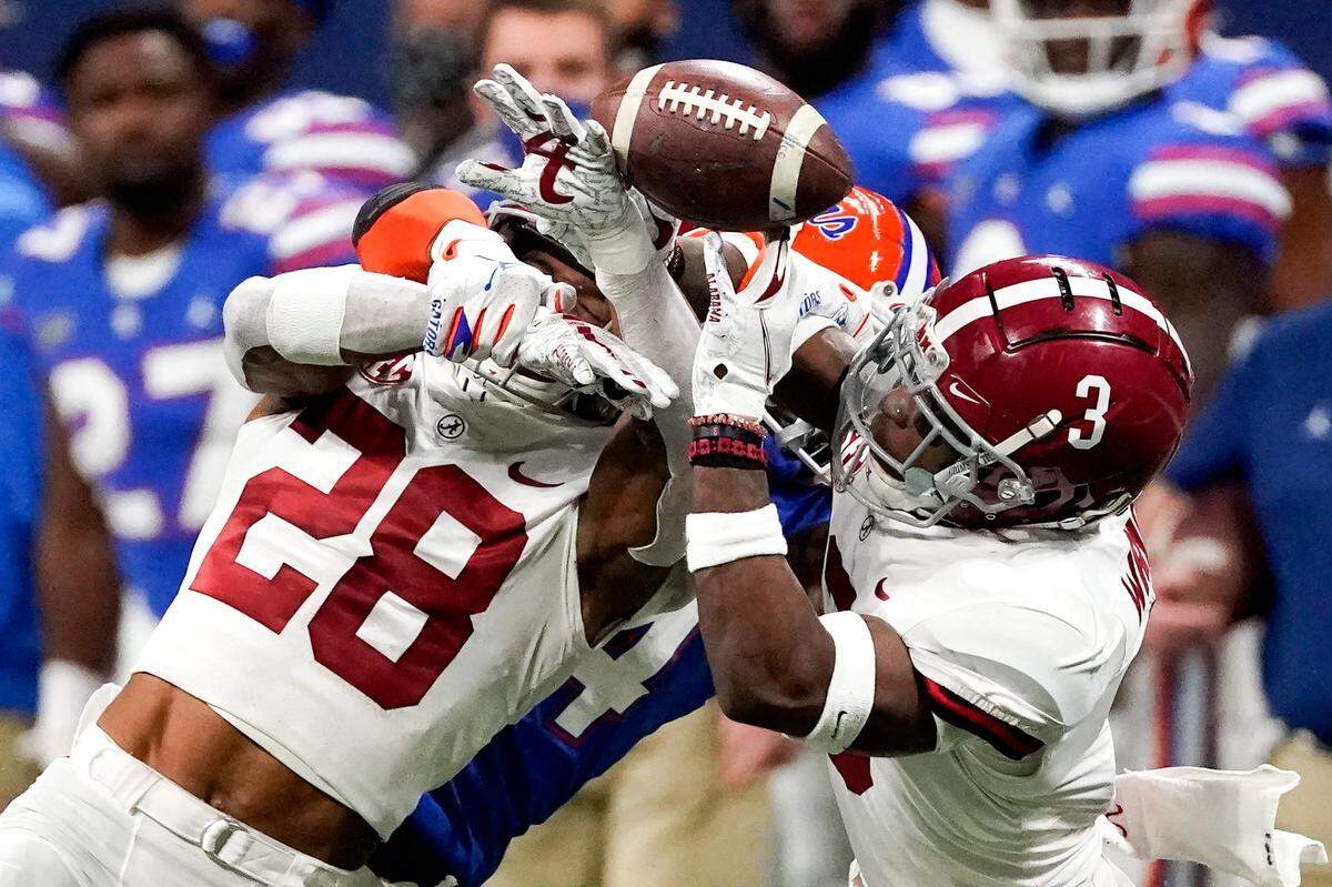 Florida tight end Kyle Pitts (84) misses the catch against Alabama’s Josh Jobe (28) and Daniel Wright (3) during the second half of the Southeastern Conference championship NCAA college football game, Saturday, Dec. 19, 2020, in Atlanta. (AP Photo/John Bazemore)