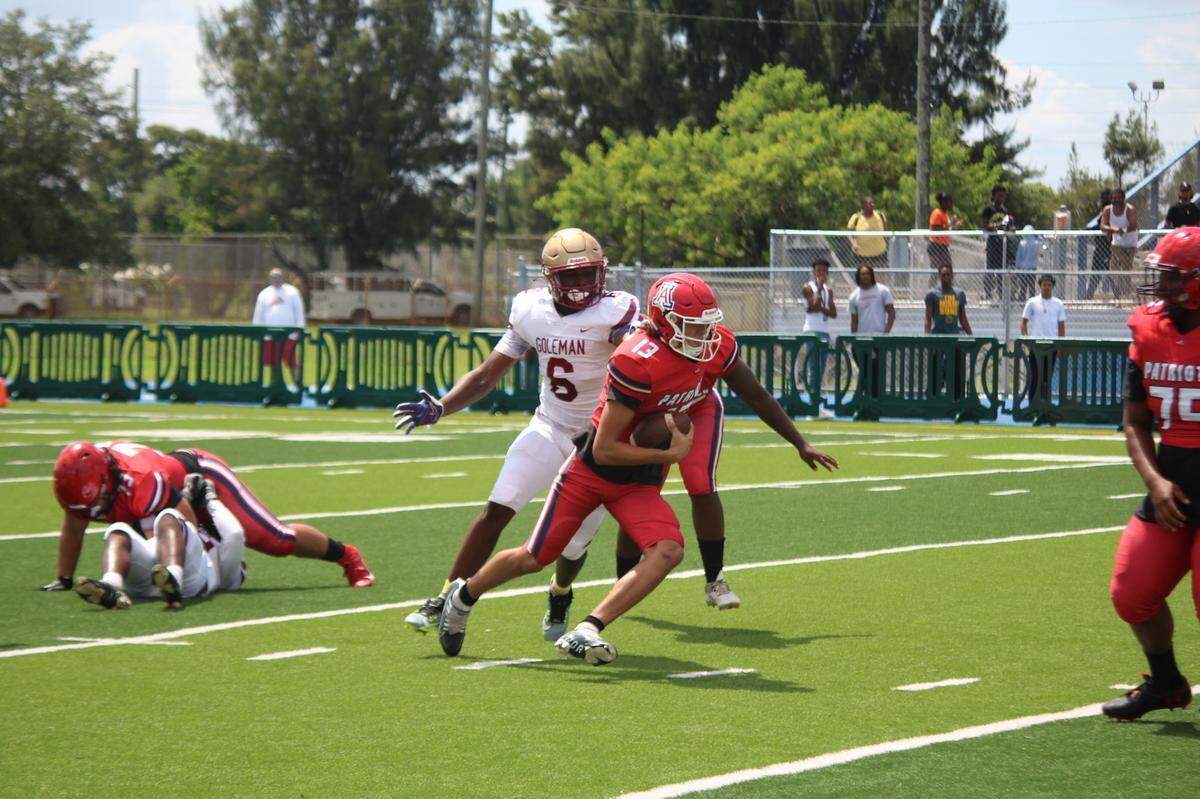 Goleman defensive end closes in on American quarterback Jack Spaeder during Wednesday afternoon’s concluded contest at Traz Powell Stadium.