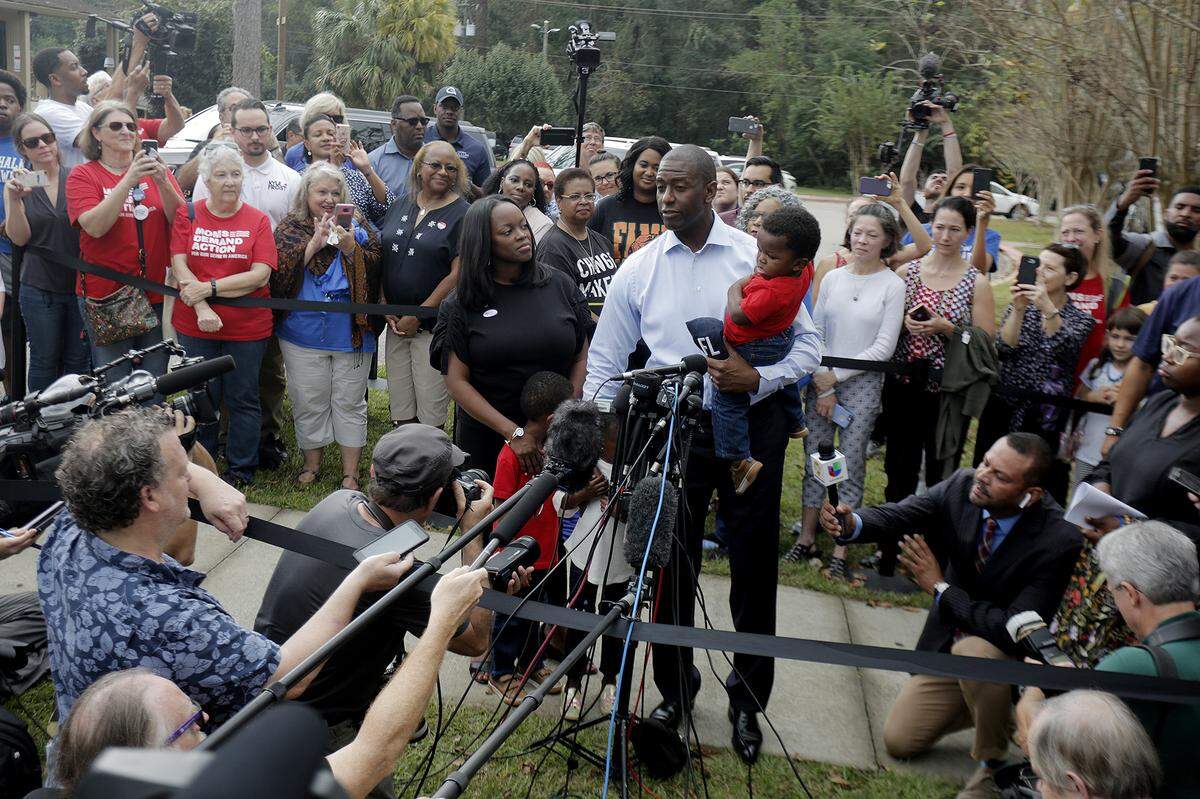Florida Democratic candidate for governor Andrew Gillum takes questions from the press while his wife R. Jai Gillum, and their three children look on after casting their ballots at the Good Shepherd Catholic Church Precinct in Tallahassee on Tuesday, Nov. 6, 2018.