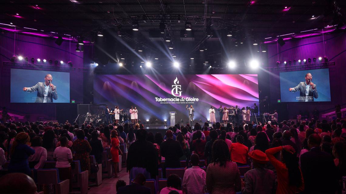 Bishop Gregory Toussaint, senior pastor and CEO of Tabernacle of Glory, center stage, conducts Sunday service at the church’s new North Miami location, one of 62 campuses worldwide.