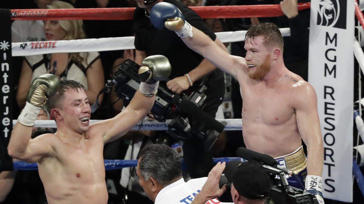 Canelo Alvarez, right, and Gennady Golovkin celebrate following a middleweight title fight Sunday, Sept. 17, 2017, in Las Vegas. The fight was called a draw. (AP Photo/Isaac Brekken)