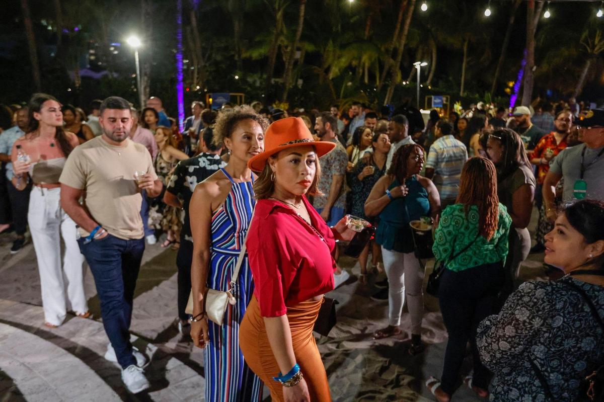 Michelle Hunter wears a stylish hat as she walks through the crowd during the Art of Tiki Cocktail Showdown at the South Beach Wine & Food Festival at the Kimpton Surfcomber Hotel in Miami Beach, Florida on Saturday, February 25, 2023.