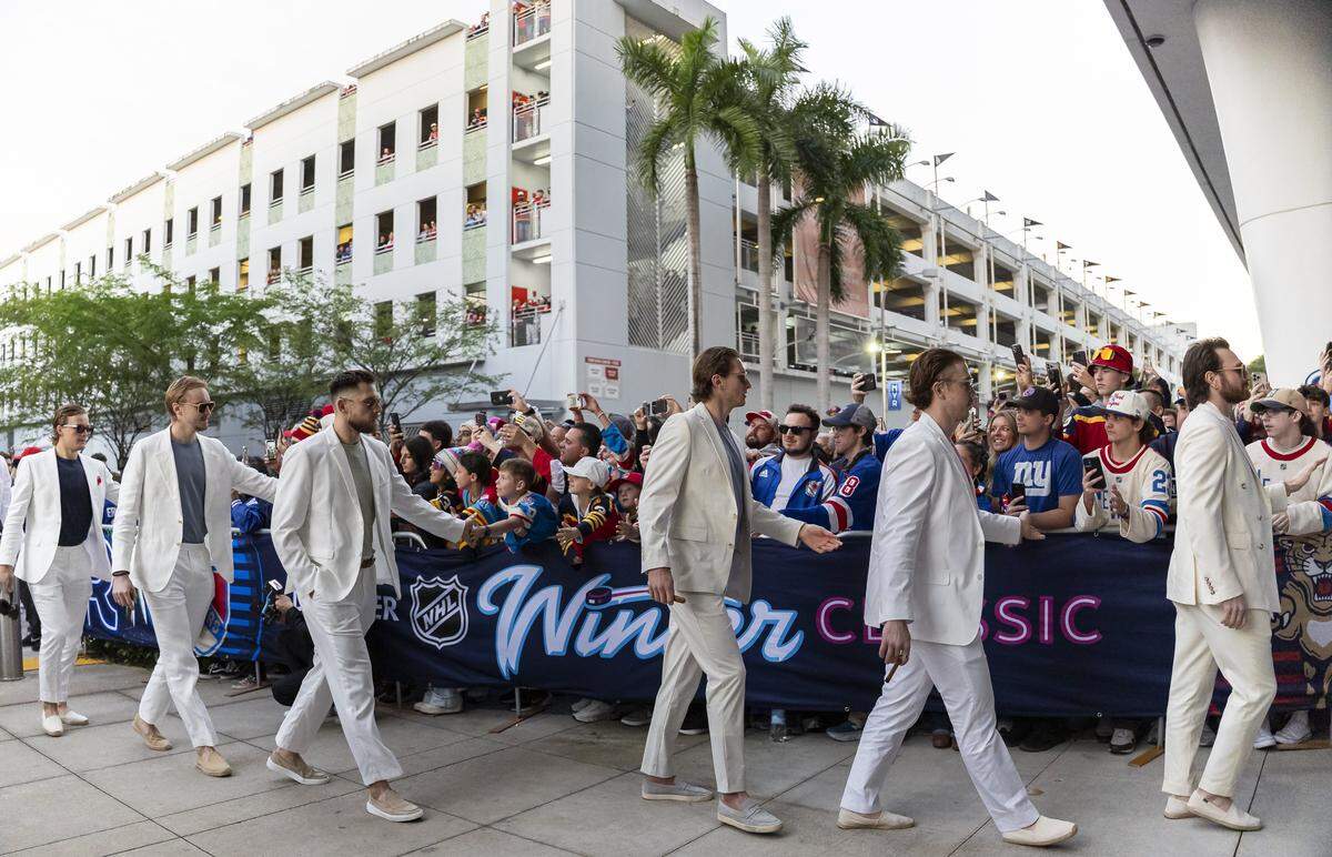 From left to right: Florida Panthers Jesper Boqvist, Daniil Tarasov, A.J. Greer, Eetu Luostarinen, Donovan Sebrango and Noah Gregor greet fans as they arrive to loanDepot for their Winter Classic outdoor hockey game against the New York Rangers on Friday, Jan. 2, 2025, in Miami, Fla.