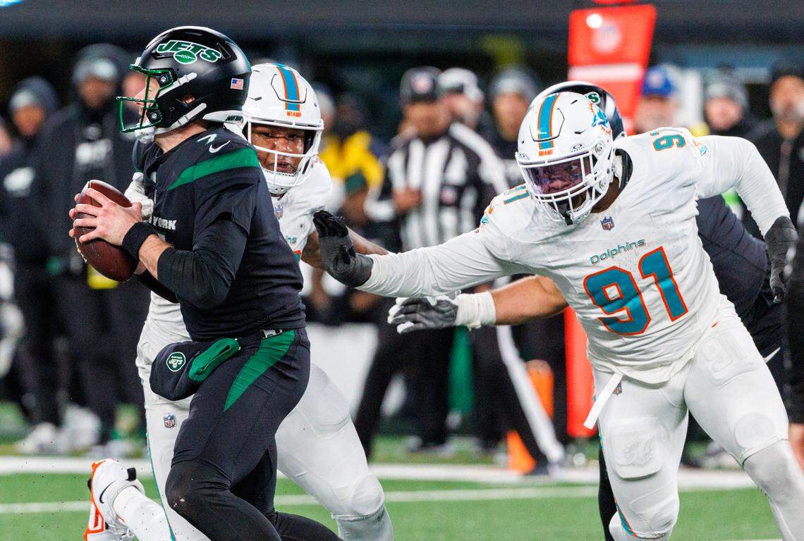 Miami Dolphins defensive end Emmanuel Ogbah (91) and Dolphins defensive tackle Da’Shawn Hand (93) defend New York Jets quarterback Tim Boyle (7) during fourth quarter of an NFL football game at MetLife Stadium on Friday, Nov. 24, 2023 in East Rutherford, New Jersey.
