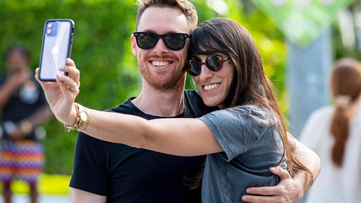 Los turistas israelíes Elad y Orit Aloni se toman un selfie en Lincoln Road en Miami, Florida, el lunes 7 de junio de 2021.