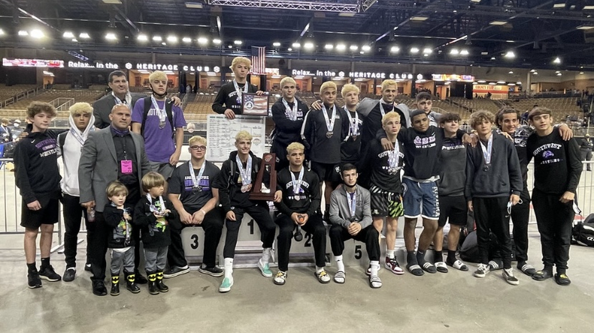 The Southwest wrestling team poses with the second-place trophy at the state championships in Kissimmee.