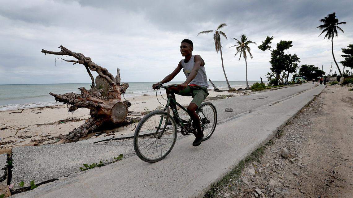 Rodley Charles, 16, rides his bicycle along Pointe-Sable Beach in Port Salut, Haiti. Nine months after Hurricane Matthew, the long-stretch of Pointe Sable remains littered with downed almond, poinciana and palm trees and tourists have yet to return to the coastal city of Port Salut, which lost most of its hotels after the storm made landfall in the region. 