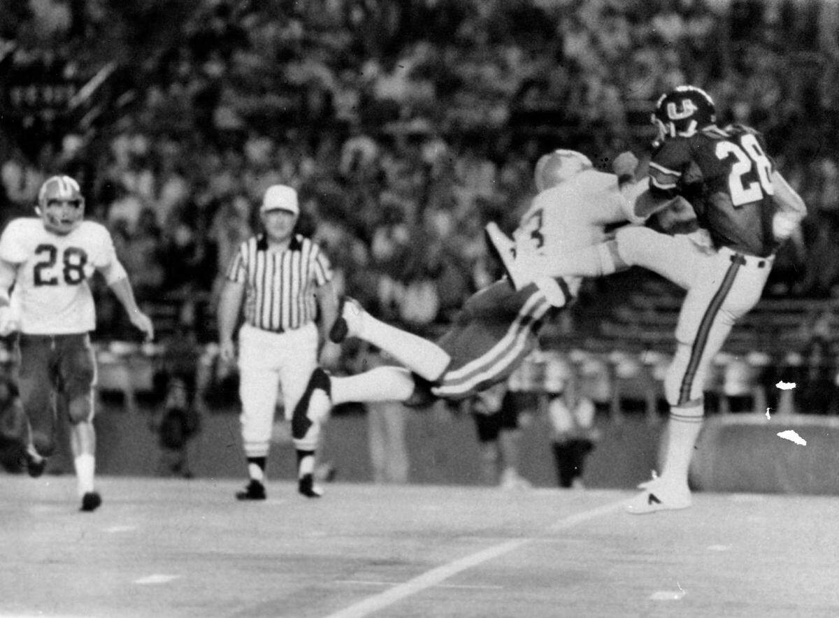 Action in 1975 game with UM hosting UF, back in the days when the Canes wore green jerseys and helmets.