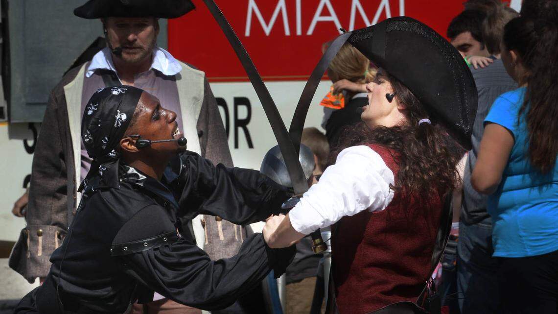 Sean Dream, (left) and Bree Anna Obst (cq right) dressed as Pirates, battle for treasure in the front of Miami Children’s Museum on Watson Island, Saturday, February, 07, 2015 as part of the opening day of the pirates display.