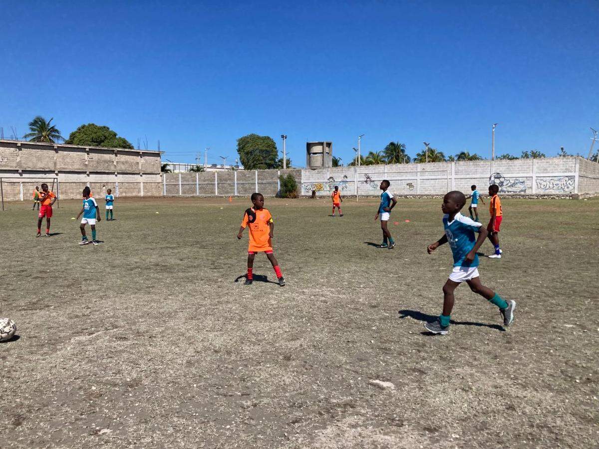 Olympique École de Football in Sarthe, Haiti provides children from some of Haiti’s poorest neighborhoods with the chance to envision another life from the hardships they know. The program recently lost its goalkeeper, Josué St. Vilus,, 11, who was killed on Saturday, May 16, 2026 when a stray bullet tore through his abdomen as his family tried to flee gang attacks.