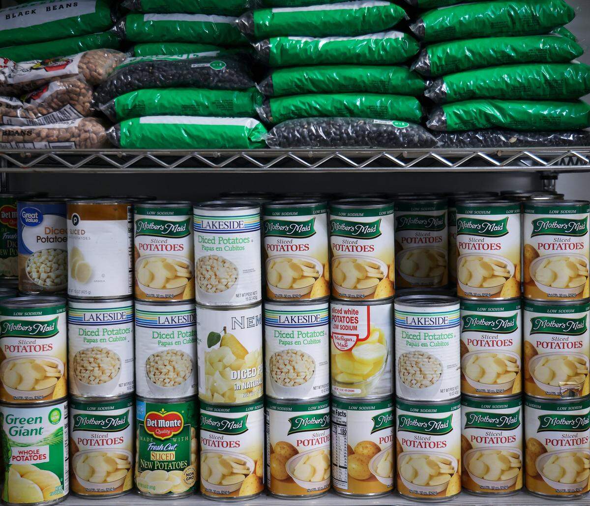 Bags of dried beans and canned goods are stacked up at Feeding South Florida’s pantry in Pembroke Park. Feeding South Florida had to cut its budget significantly to make up for a $17 million loss in federal funds under the Trump administration.