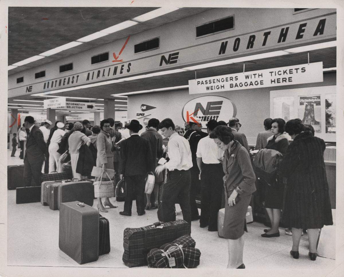 Travelers line up at the Northeast Airlines counter in 1966.