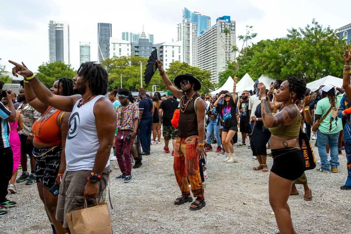 Festival goers listen and dance to music during AFROPUNK at The Urban in the Historic Overtown neighborhood of Miami, Florida, on Saturday, May 21, 2022.