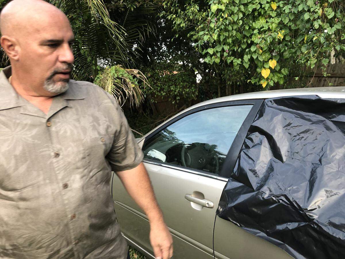 Nick Humet stands with the car his brother Jaime Humet was killed in Dec. 19, 2018. Jaime Humet was killed Dec. 10, 2018, and police are still looking for his killer.