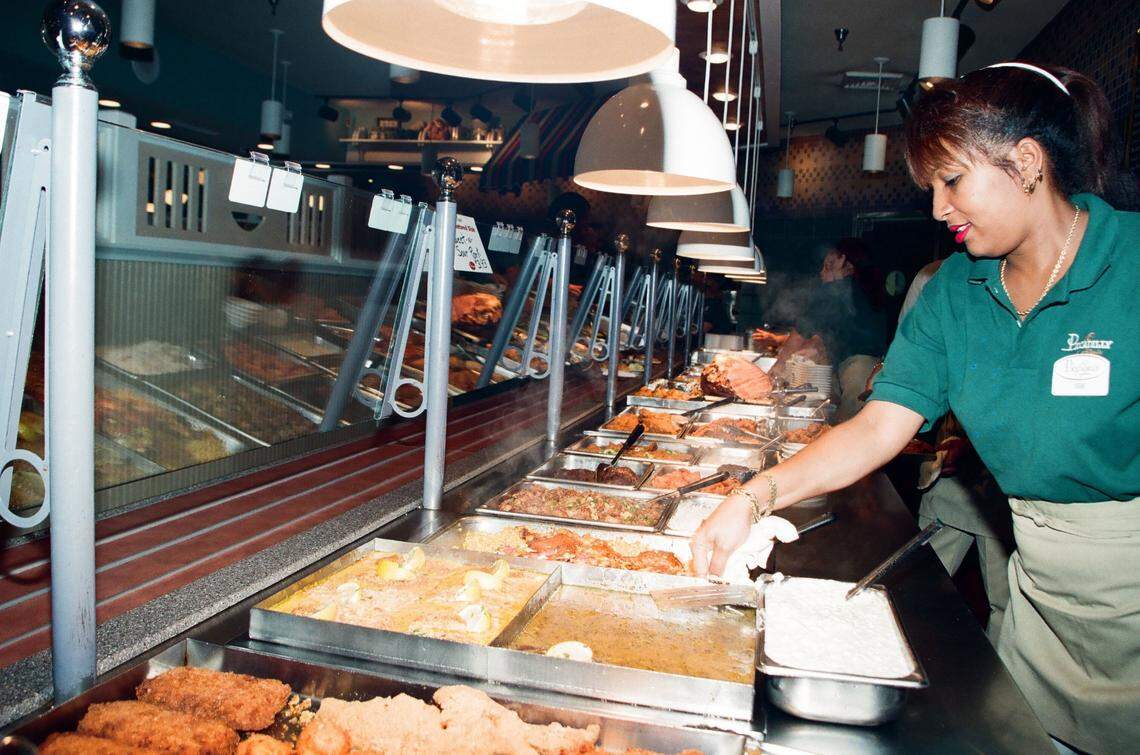 Workers prepare the buffet at Piccadilly Cafeteria.