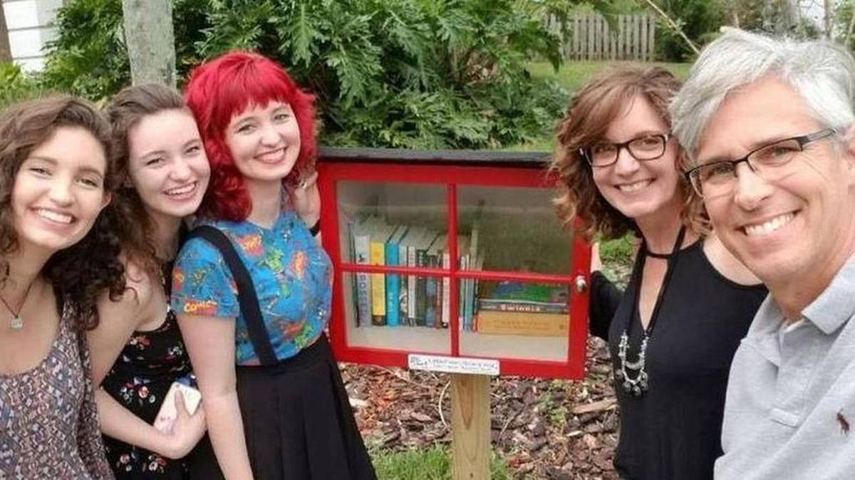 The Garicks of Bentley Woods in Oviedo pose with their Little Free Library. (Courtesy, Autumn Huff Garick)