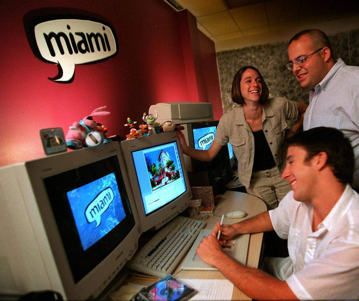 Front to back, Lloyd Alvarez, seated, Chris Sloan, top right, and Cheryl Lefkowitz, back left. staffers at WAMI-TV, a new TV Station in Miami