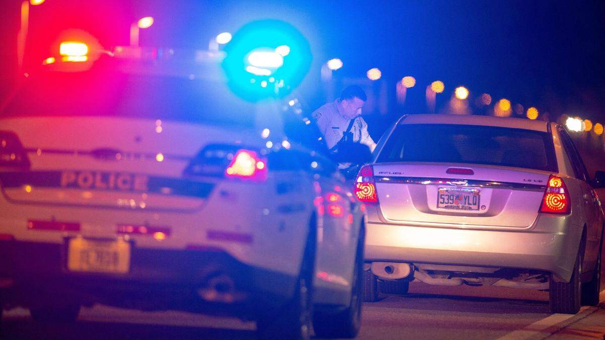 A Miami-Dade officer speaks to a driver at a DUI checkpoint.