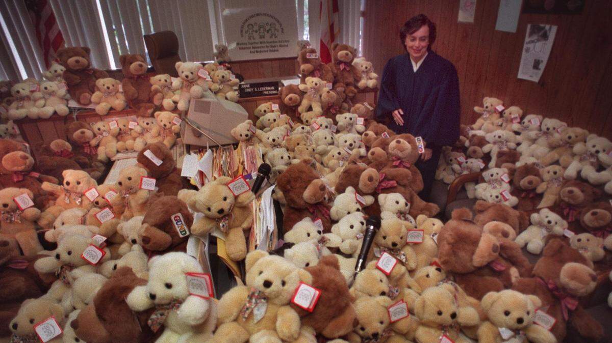 Following a 1998 news conference at the Miami Juvenile Justice
Center, Judge Cindy Lederman made her way through an avalanche of teddy
bears that descended on her courtroom to herald the the "Bear Necessities" program for abused, neglected or abandoned children.  It was a joint campaign between the 11th Judicial Circuit and Voices For Children Foundation. Close to 1,000 bears were donated to be
distributed to each child victim upon attending his or her abuse or
neglect case.