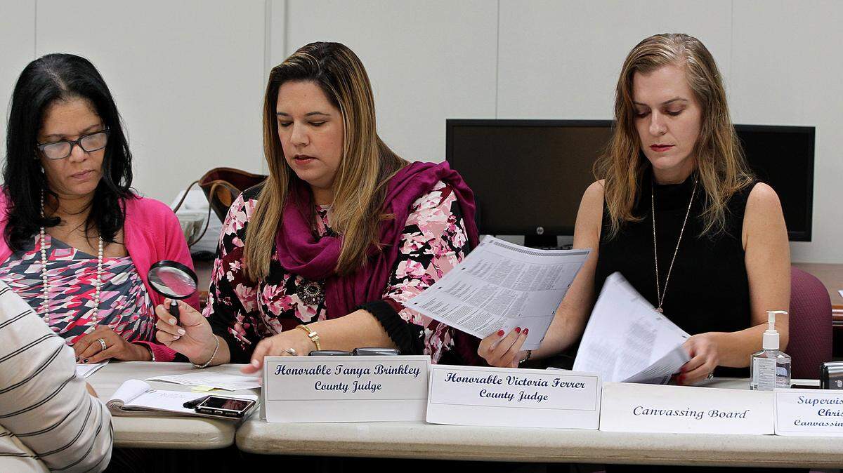 From left, Miami-Dade County Elections Department members County Judges Tanya Brinkley and Victoria Ferrer with Christina White, Miami-Dade County Elections Supervisor, review ballots as part of the recount process in Doral on Saturday November 17, 2018.