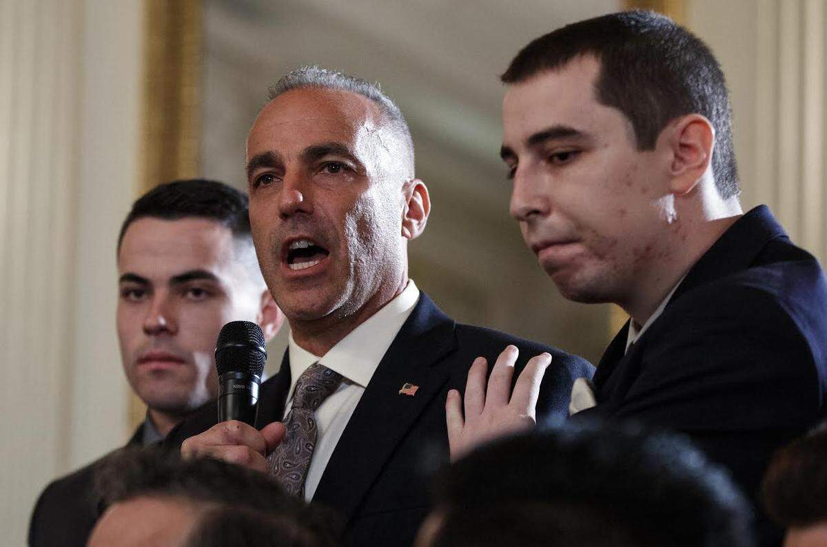 Andrew Pollack, father of slain Marjory Stoneman Douglas High School student Meadow Jade Pollack, joined by his sons, speaks during a listening session with President Donald Trump, high school students, teachers and others in the State Dining Room of the White House in Washington, Wednesday, Feb. 21, 2018. (AP Photo/Carolyn Kaster)