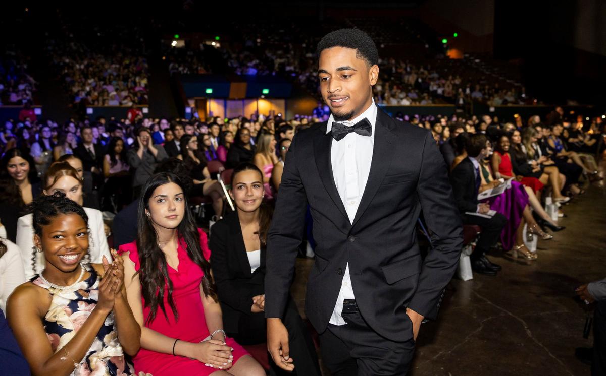 Silver Knight winner Reo Gay, from Western High School, walks to the stage after winning in the Digital & Interactive Media category during the Miami Herald & el Nuevo Herald 66th Silver Knight Award Ceremony at the James L.&nbsp;Knight&nbsp;Center on Wednesday, May 22, 2024, in downtown Miami, Fla.