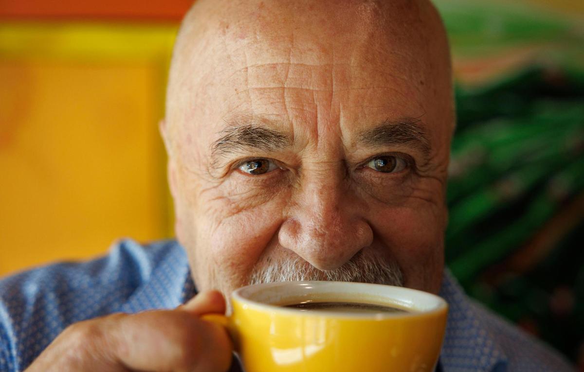 Fabio Caro, owner of Macondo Coffee, poses with a coffee during the morning on Tuesday, Feb. 18, 2025, at Macondo Coffee in Doral, Florida. Caro is passionate about coffee and puts effort into creating a community at his shops where the coffee, at every shop, tastes the same.