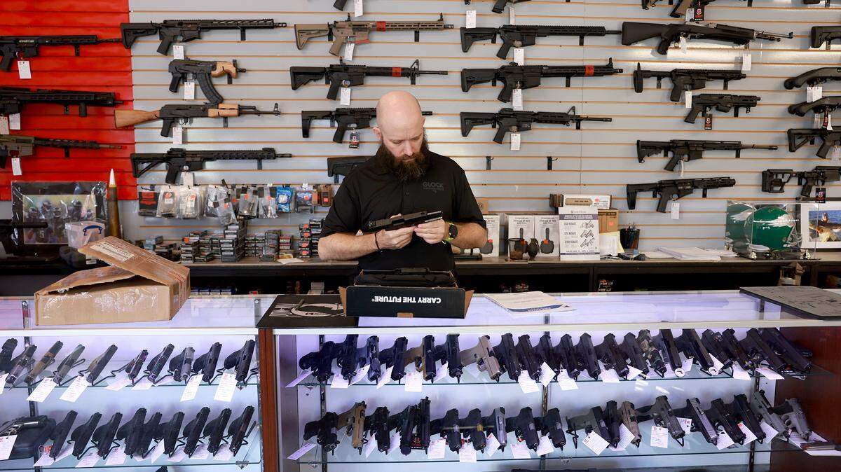 Ian Bravender inventories a handgun at the WEX Gunworks store on January 31, 2023 in Delray Beach, Florida. 