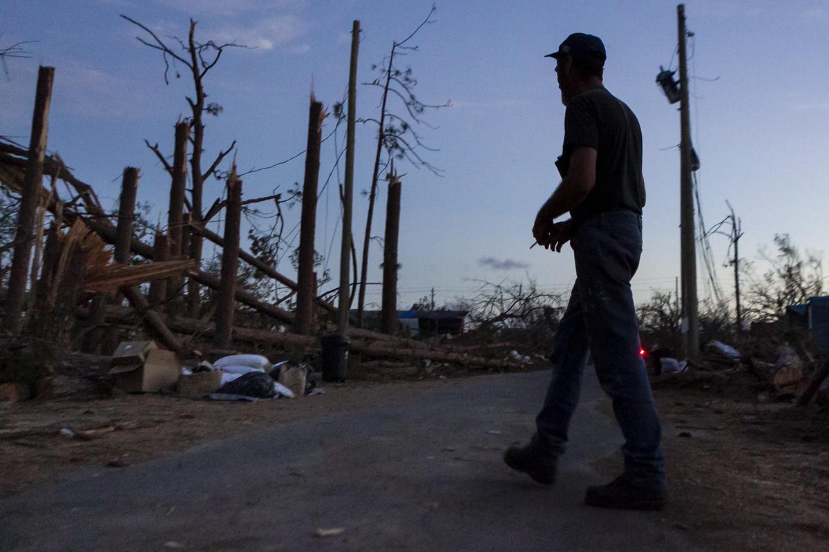 Carl Kuhn walks through the streets of Callaway, Florida, where he is now known as “the hero of Fox Avenue” on Saturday, Oct. 20, 2018. Kuhn rescued his neighbors from the wreckage of their trailer during the eye of Hurricane Michael.