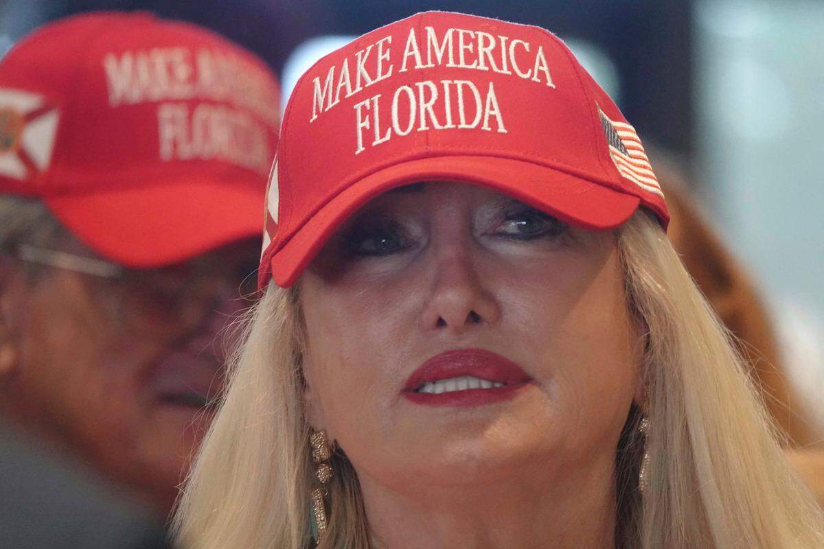 Florida Gov. Ron DeSantis supporter Kerry Kensington of North Palm Beach looks on at an event in West Palm Beach, where DeSantis announced proposed election reform laws, Wednesday, Nov. 3, 2021.