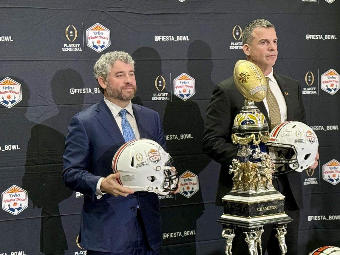 Ole Miss Rebels coach Pete Golding (left) and Miami Hurricanes coach Mario Cristobal pose with the Fiesta Bowl Trophy at the Camelback Inn Resort and Spa on Wednesday, Jan. 7, 2026, in Paradise Valley, Arizona.