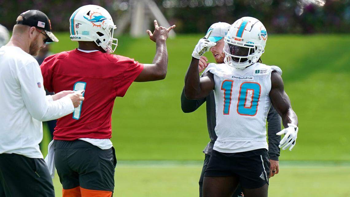 Miami Dolphins quarterback Tua Tagovailoa (1) and wide receiver Tyreek Hill (10) take part in drills at the NFL football team’s practice facility, Thursday, June 2, 2022, in Miami Gardens, Fla. (AP Photo/Lynne Sladky)