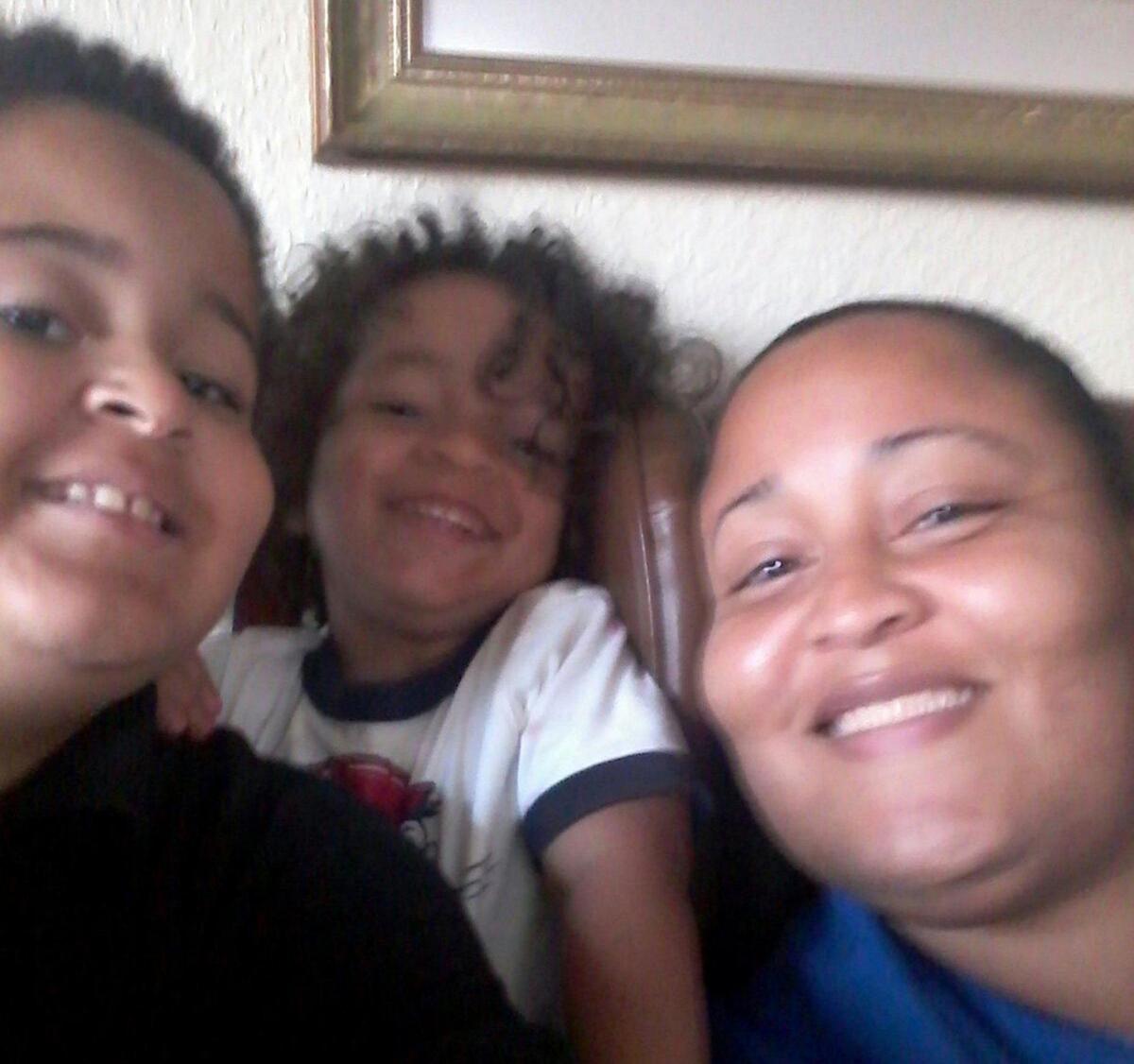 A family picture of Rosa Felipe with her sons Saiid Marte (far left) and Ishaan Marte. She is a Jackson Hospital health care worker who was one of the first to contract COVID-19 and remains in the hospital.